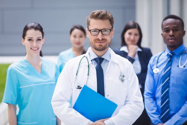 Portrait of smiling doctors standing together in hospital premises